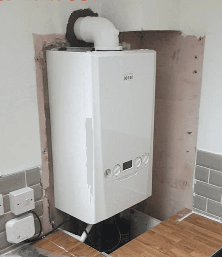 Same kitchen wall with a new Ideal combi boiler installed, neat pipework tucked away ready for the cabinets to go back