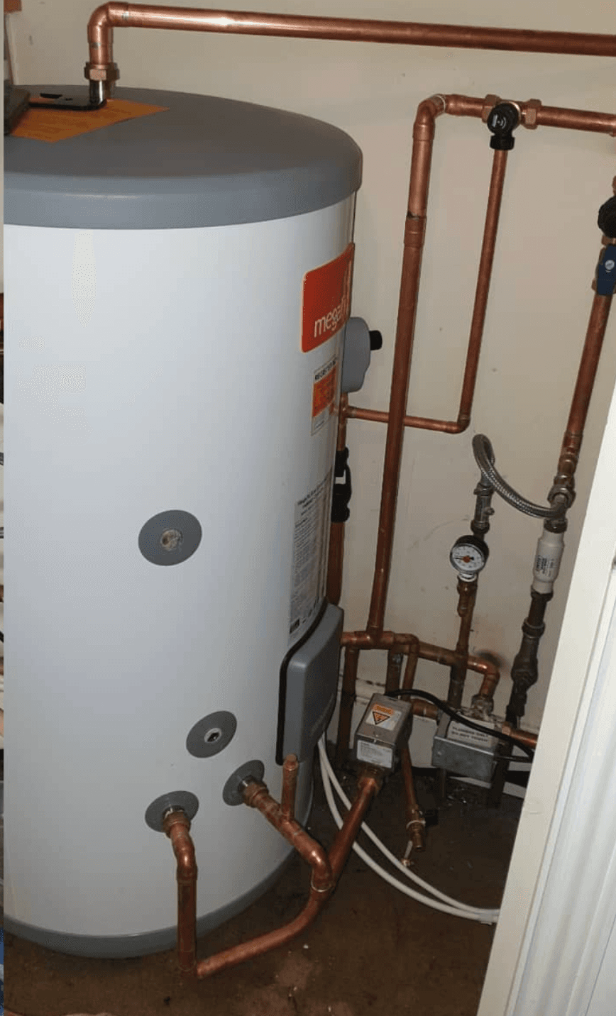 New unvented hot-water cylinder installed in the same airing space, copper pipework re-routed cleanly with new valves