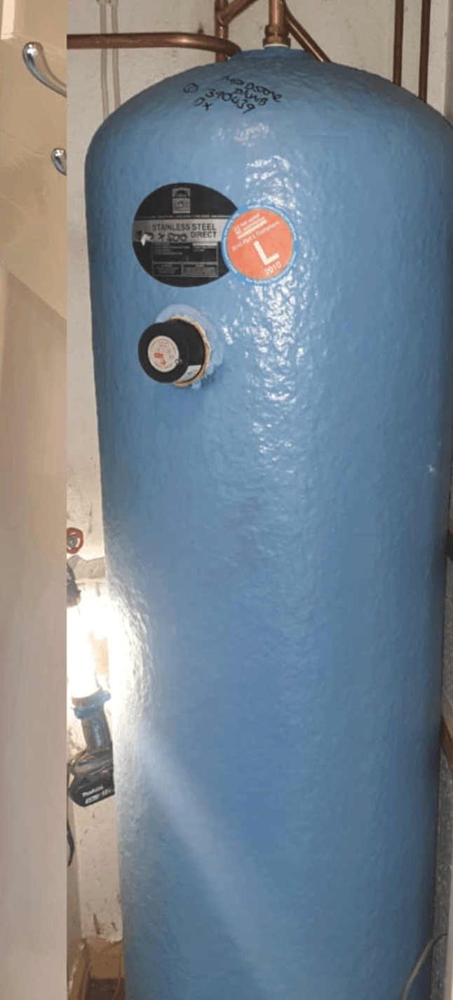 New light-blue hot-water cylinder installed in the same cupboard, fresh copper pipework and clean insulation